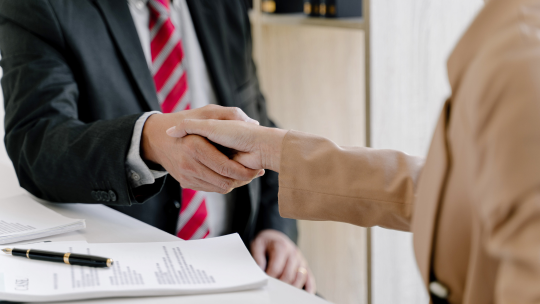 A satisfied client shaking hands